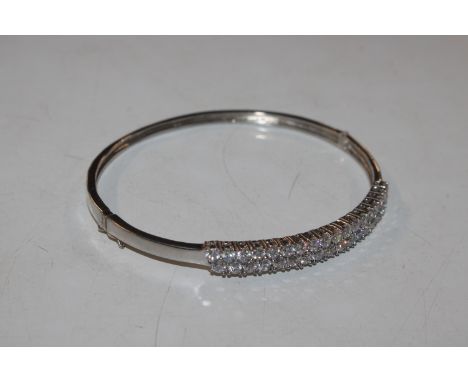 A Sterling silver bangle with double row of Cubic Zirconia stones 