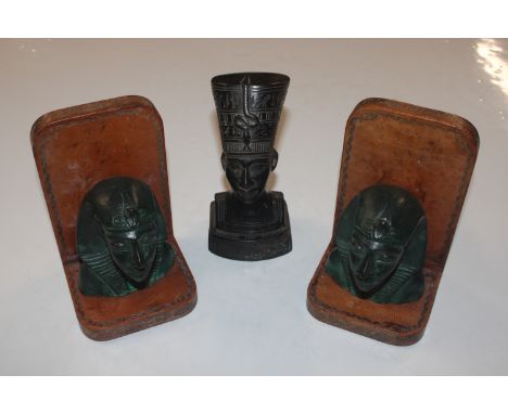 An Egyptian Revival carved bust; and a pair of Egyptian Revival bookends stamped "Made In Italy For Liberty"