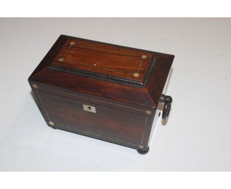 A 19th Century mother of pearl inlaid sarcophagus shaped two compartment tea caddy with ring handles raised on bun supports 