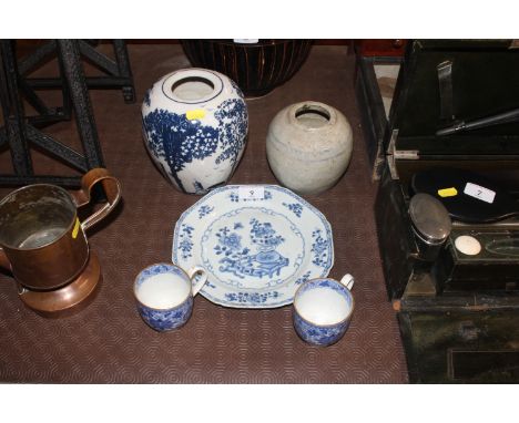 A 19th Century octagonal blue and white plate; a pair of blue and white cups and saucers; a blue and white crackle glazed vas