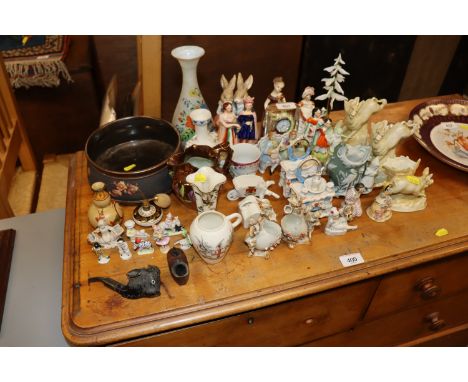 A quantity of various decorative china to include Staffordshire figures; a pipe in the form of a cows head; pipe bowl in the 