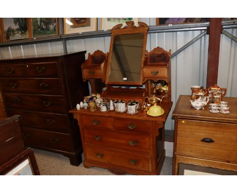 A late Victorian satin walnut dressing chest with swing mirror and drawers above, two short and two long drawers below 