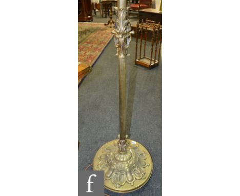 A 20th Century brass standard lamp on domed scroll cartouche base, height 171cm and a wrought iron ceiling light fitting. (2)