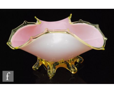 A late 19th Century Stourbridge glass posy bowl of tri-form cased in opal over pink and decorated with an applied golden ambe