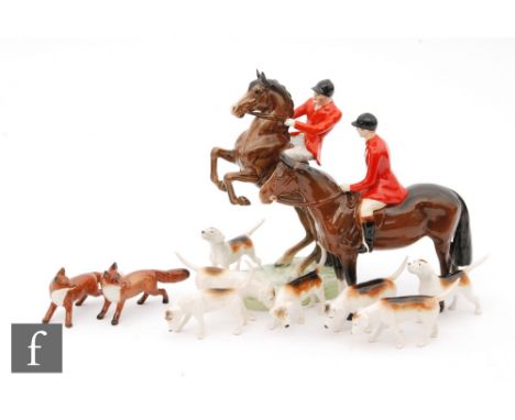 A Beswick hunting group comprising a model 868 rider on horseback, 868, a model 1501 huntsman, restored, seven hounds and two