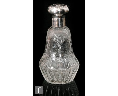 An early 20th Century Stourbridge clear crystal scent or cologne bottle of low shouldered form with a tapered body, polished 