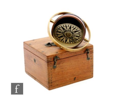 A 20th Century mahogany cased ships compass in a brass gimble frame, unnamed dial, diameter 10cm. 