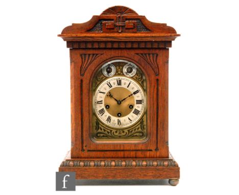 An early 20th Century Junghans oak cased eight day strike mantle clock, Roman numerals to a silvered chapter ring below two s