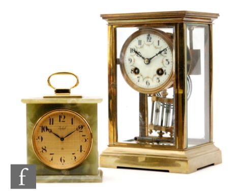 An Edwardian brass mantle clock with painted floral circular dial above a mercury suspended pendulum, height 22cm, also a sma