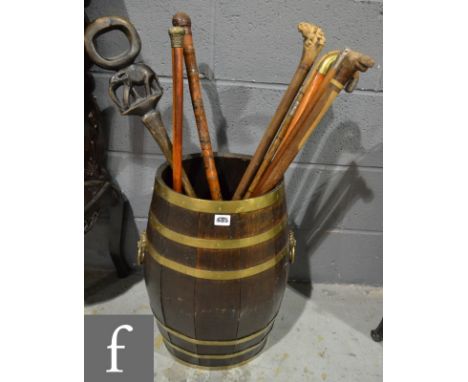 A coopered oak barrel stick stand, with ring loop handles, height 55cm and width 35cm across the handles, together with a col