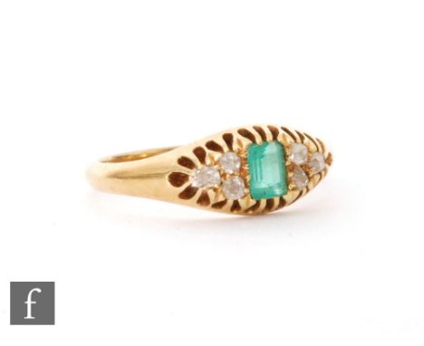 A 19th Century 18ct emerald and diamond ring, central emerald cut emerald flanked by three diamonds to each side, weight 3.8g