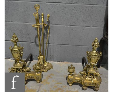 A pair of 19th Century French brass chenets of classical urn form supported on iron stands, height 47cm and a matching set of