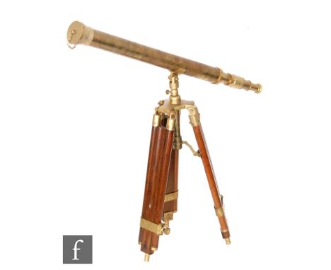 A contemporary reproduction brass telescope on an adjustable brass mounted mahogany stand, S/D. 
