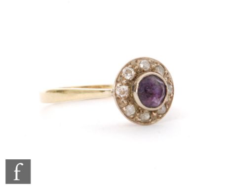 A modern 18ct hallmarked amethyst and diamond cluster ring, central collar set amethyst within a eight stone diamond surround