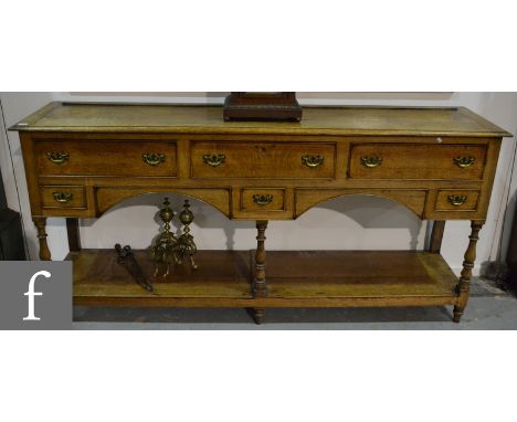 A George III light oak dresser, fitted with three frieze drawers above three short drawers, later fret brass drop handles on 