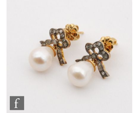 A pair of silver gilt cultured pearl and diamond drop earrings, tear shaped pearl below diamond set tied ribbon stud, lengths