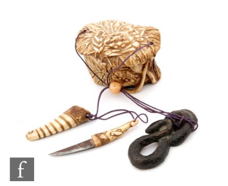 A Japanese early 20th Century horn inro, carved as a series of lotus leaves overlapping, forming a lidded box, adorned with a