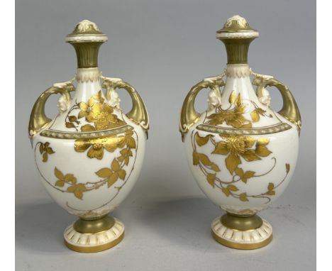 A PAIR OF ROYAL WORCESTER URNS AND COVERS (LACKING FINIALS) WITH FLORAL GILT DECORATIONStamped to verso Rd No. 214562
