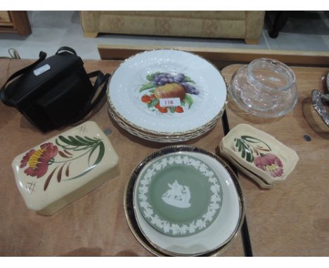 A selection of decorative plates and a camera
