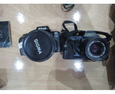 A Cannon T70 camera and a Nikon F50 with Sigma 28-200mm zoom lens