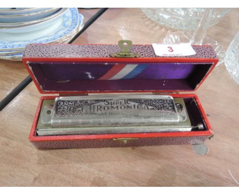 A vintage Hohner Super Harmonica (chromatic) in original box