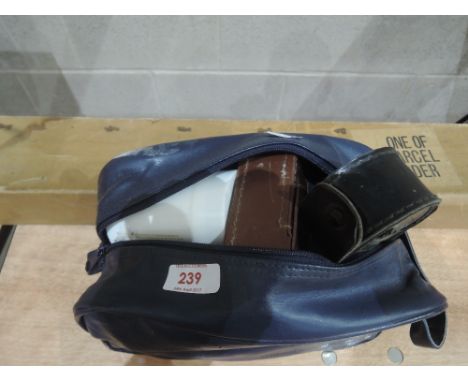 A blue bag of camera spares etc and projector screen