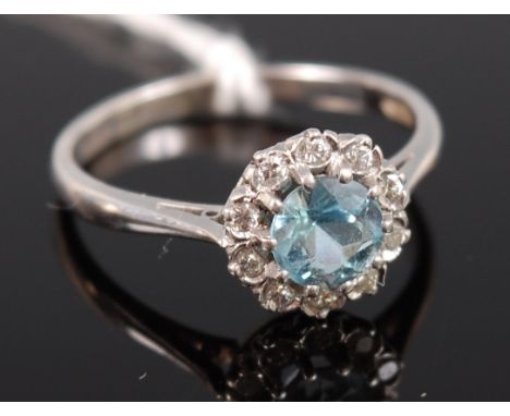 A modern 18ct gold aquamarine and diamond set flowerhead cluster ring, size R+