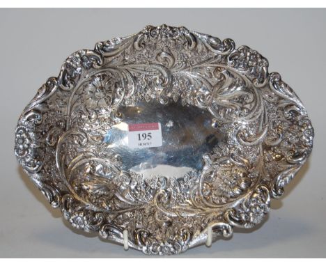 A late Victorian silver dish, having all-over repousee floral decoration, by Goldsmiths & Silversmiths Co (William Gibson & J