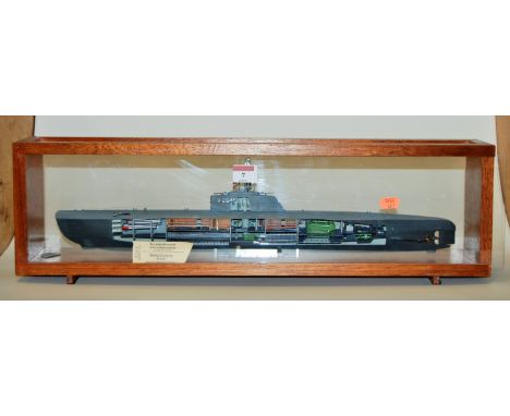 A plastic kit model of a submarine type XX1U-2540 in glazed display case 