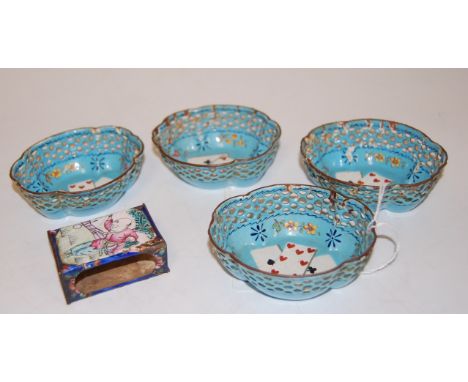 A set of four early 20th century enamel dishes, each of pierced scalloped oval form, having central playing card decoration w