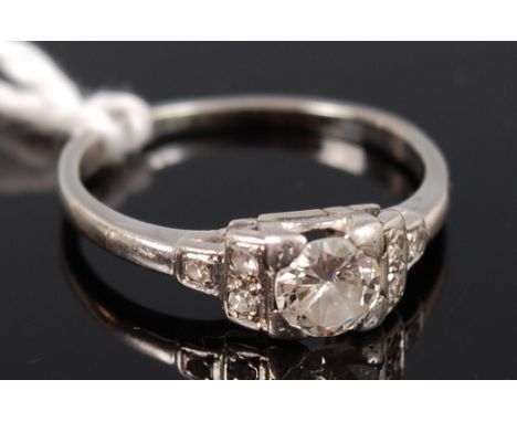 An 18ct white gold and platinum set diamond solitaire ring, the four claw set brilliant weighing approx 0.39 carat, the shoul