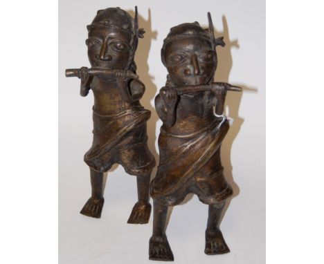 A pair of Benin(?) bronze figures, each in the form of a standing man blowing a horn, h.40cm 