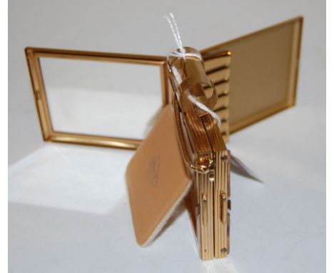 A ladies Art Deco style engine turned gilt metal combination compact/cigarette case