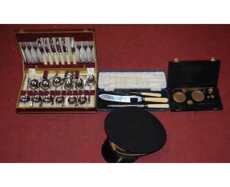 A British Rail peaked cap together with a boxed set of brass scales and weights, cased carving set etc