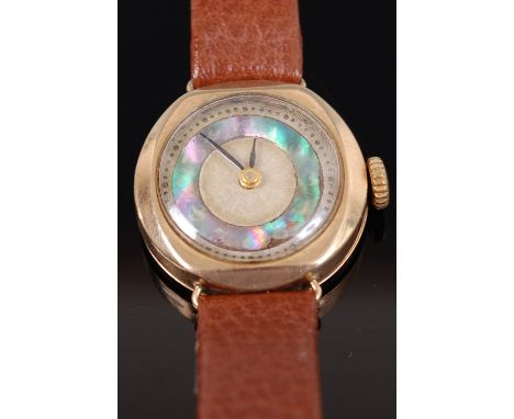 A ladies 9ct gold cased wrist watch having a mother-of-pearl chapter ring, manual wind movement, replacement leather bracelet