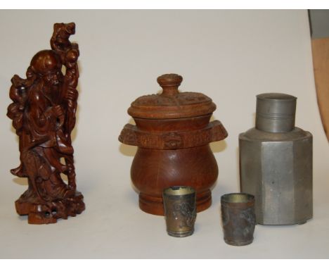 An early 20th century Chinese style pewter tea caddy of octagonal form together with a carved softwood figure of a sage, pair