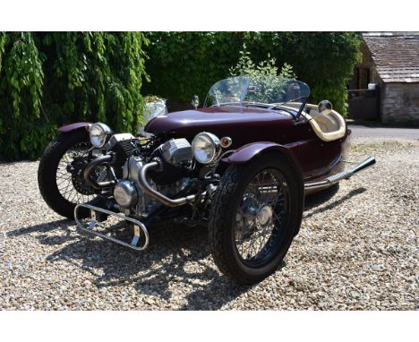 A 2015 Triking tourer, registration number R121 OUS, maroon.  Triking, founded by Tony Divey as an independent sports car man