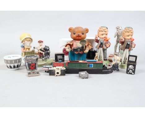 Photographic Memorabilia, including ceramic figurines, various periods, teddy bear and camera ashtray, glasses, mugs, pencil 