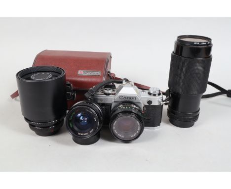 A Canon AE-1 SLR Camera with Lenses and Accessories, comprising an AE-1 body, serial no 4625755, shutter working, meter respo