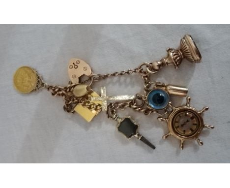 A 9ct charm bracelet, with 1914 half sovereign and French enamel & diamond set book opening to reveal cameo on spring