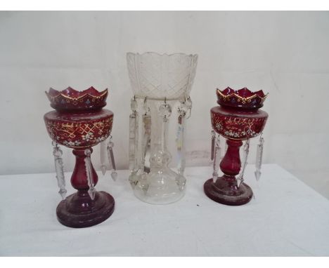 A pair of Victorian ruby glass lustres; together with one other