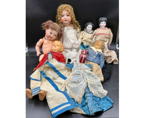 A Victorian doll's dress and cape together with a collection of mainly 19thC dolls to include a Heubach Koppelsdorf 320.6 Ger