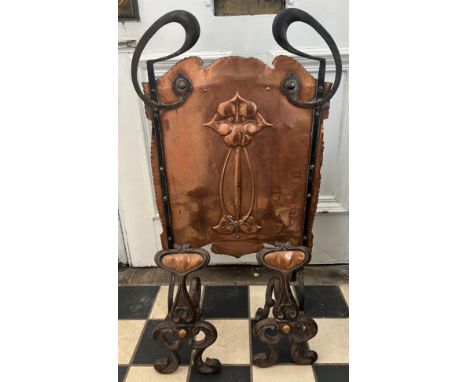 An Art Nouveau copper and iron firescreen together with a pair of Art Nouveau fire dogs. Firescreen 80cm x 49cm. 