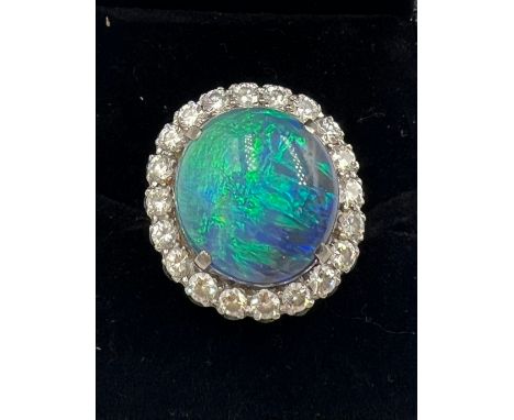 An opal and diamond ring set in 18 carat white gold. Size M. Weight 5.9gm. 