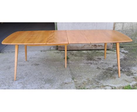 A mid 20thC Ercol extending dining table. Closed 82cm h x 152cm l x 91cm w, fully open 223cm l. 