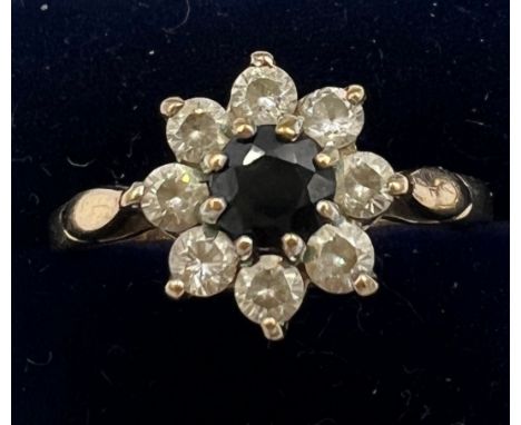 A nine carat gold cluster ring with sapphire and diamonds. Size R. Weight 2.2gm. 