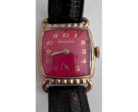 A 1952 gold plated manual dark red Bulova enamelled dial. With guarantee and Bulova case. Good working order. 