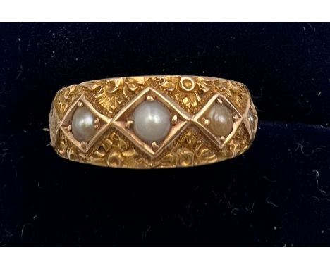 A Victorian 15 carat gold ring set with seed pearls. Size R. Weight 3.8gm. 