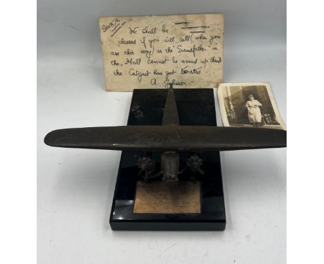 A metal model of The Southern Cross on marble base 16cm x 9cm with plaque inscribed Miss Amy Johnson in admiration from Jo &a