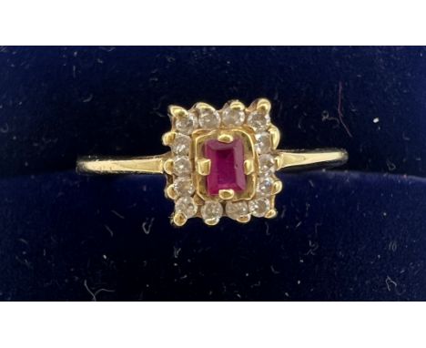 An 18 carat gold ring set with ruby and diamonds. Size M, weight 2.8gm. 